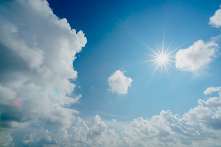 Sol entre las nubes en un cielo azul